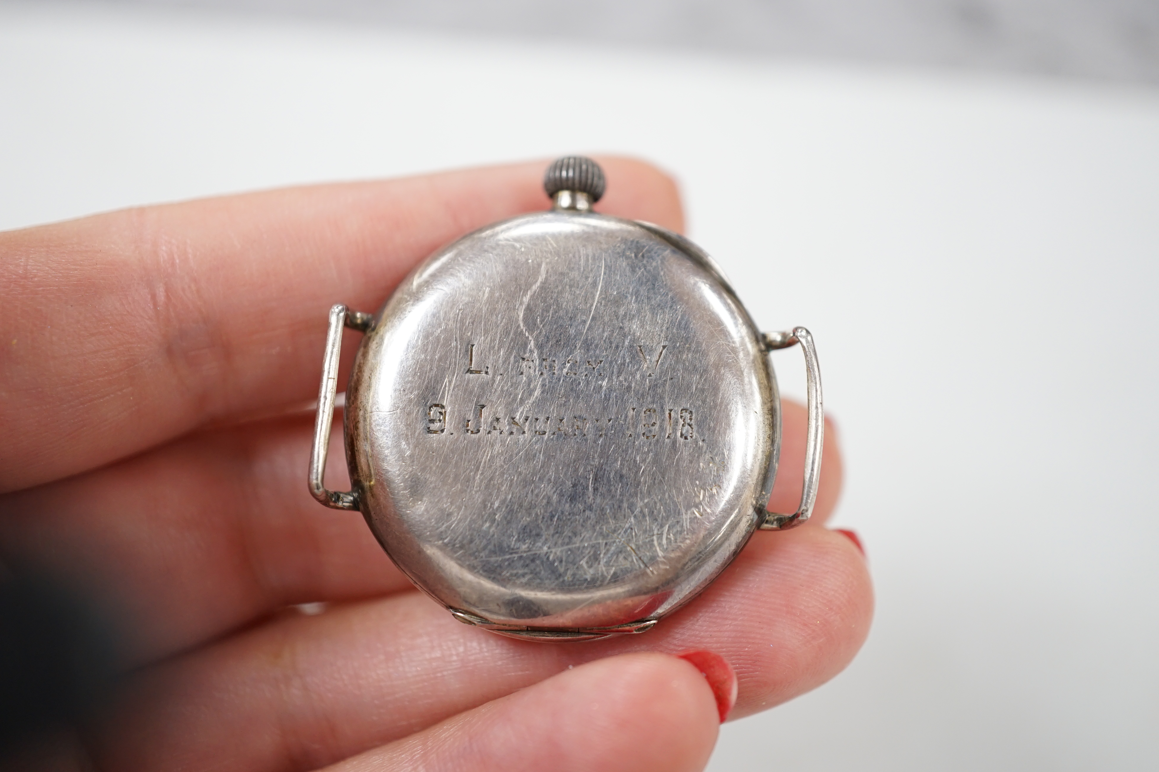 Two early 20th century silver manual wind wrist watches including black dial, both with subsidiary seconds, no straps.